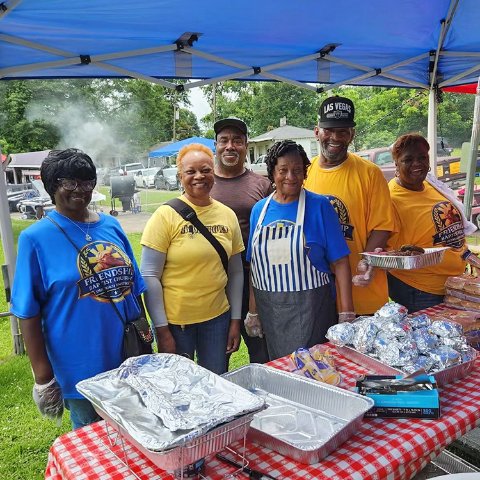 Volunteers serving food at a community cookout